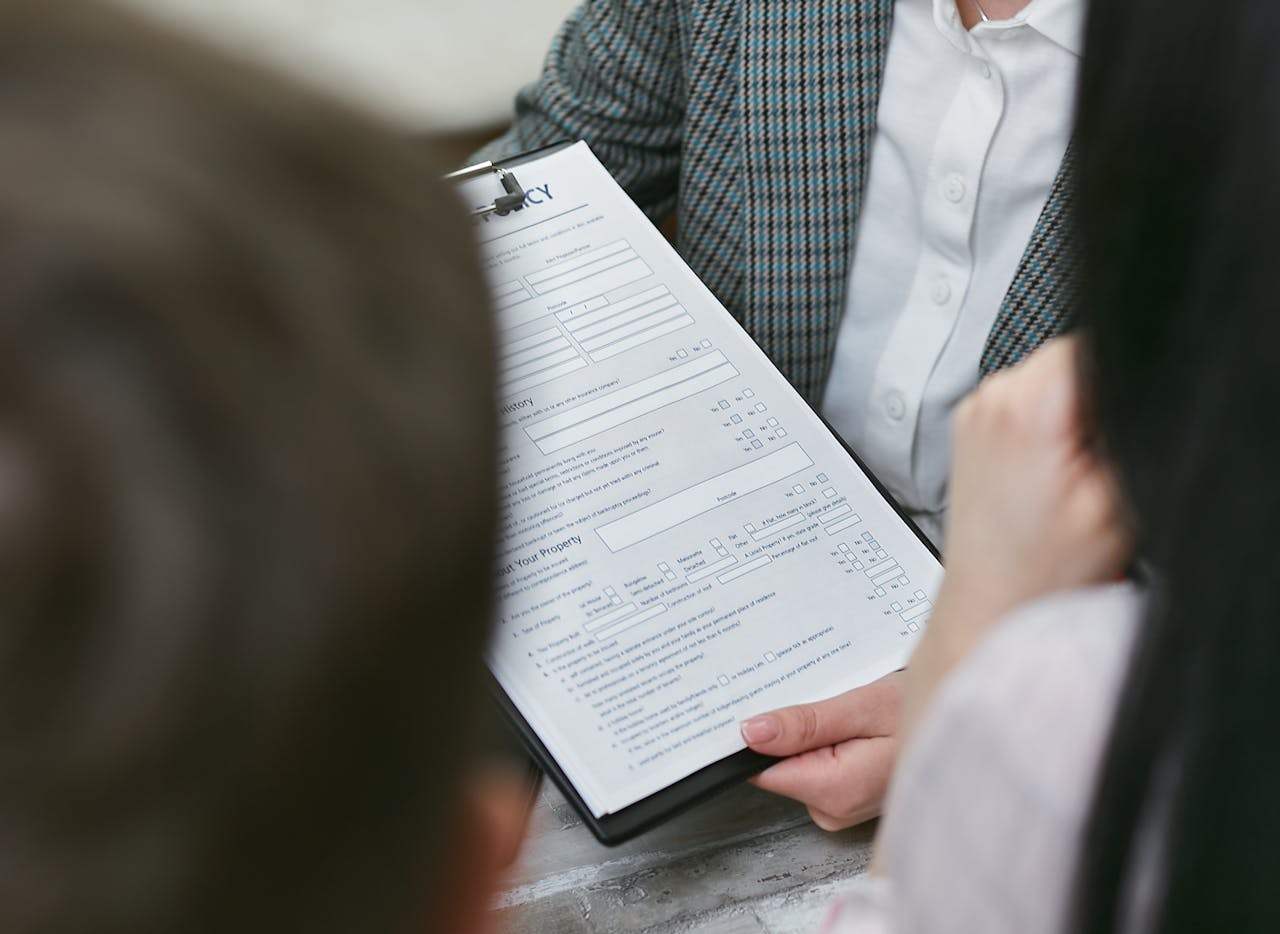 gallery-02 Close-up of professionals discussing a legal contract during a business meeting.